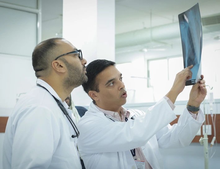 Dr Yash Khatod reviewing a chest radiograph with a colleague
